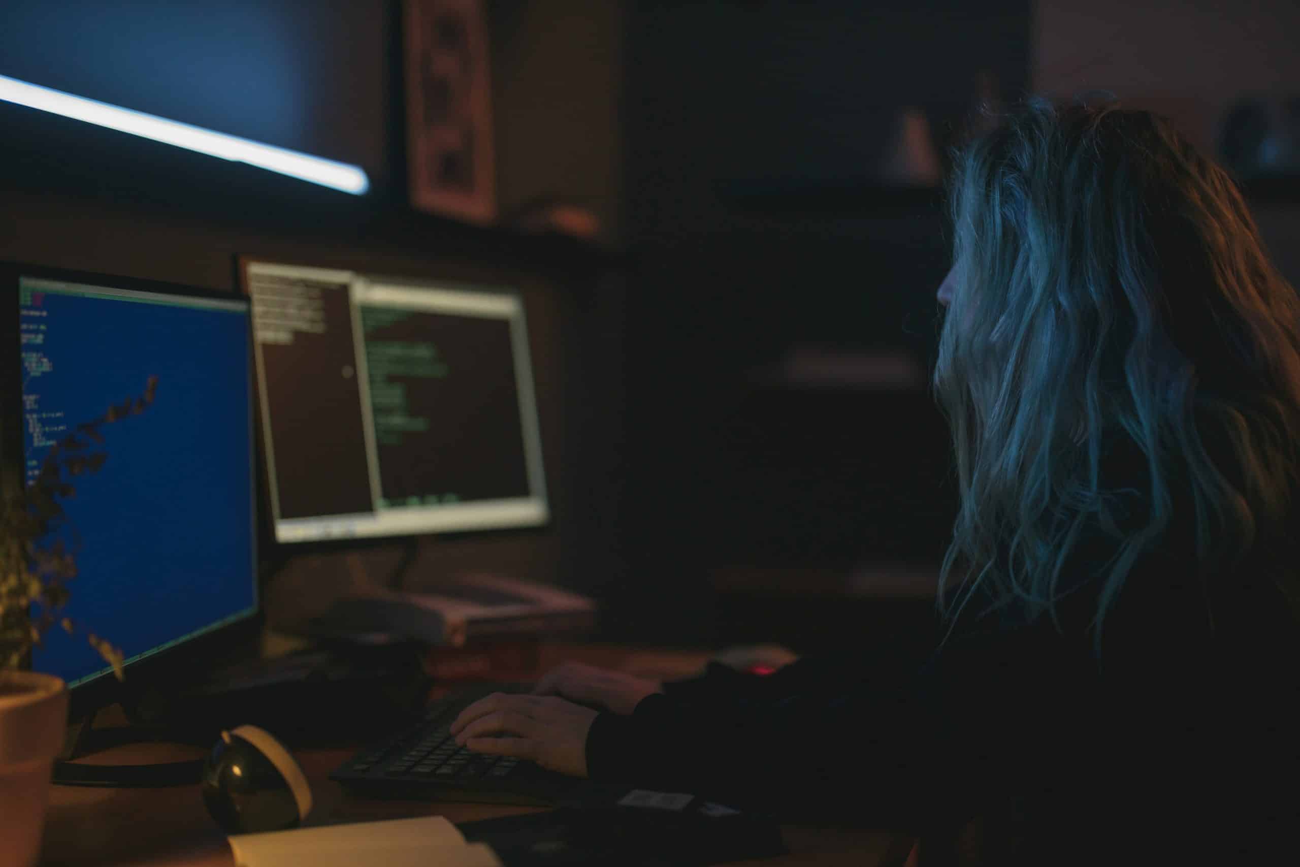 A woman typing and working on her laptop